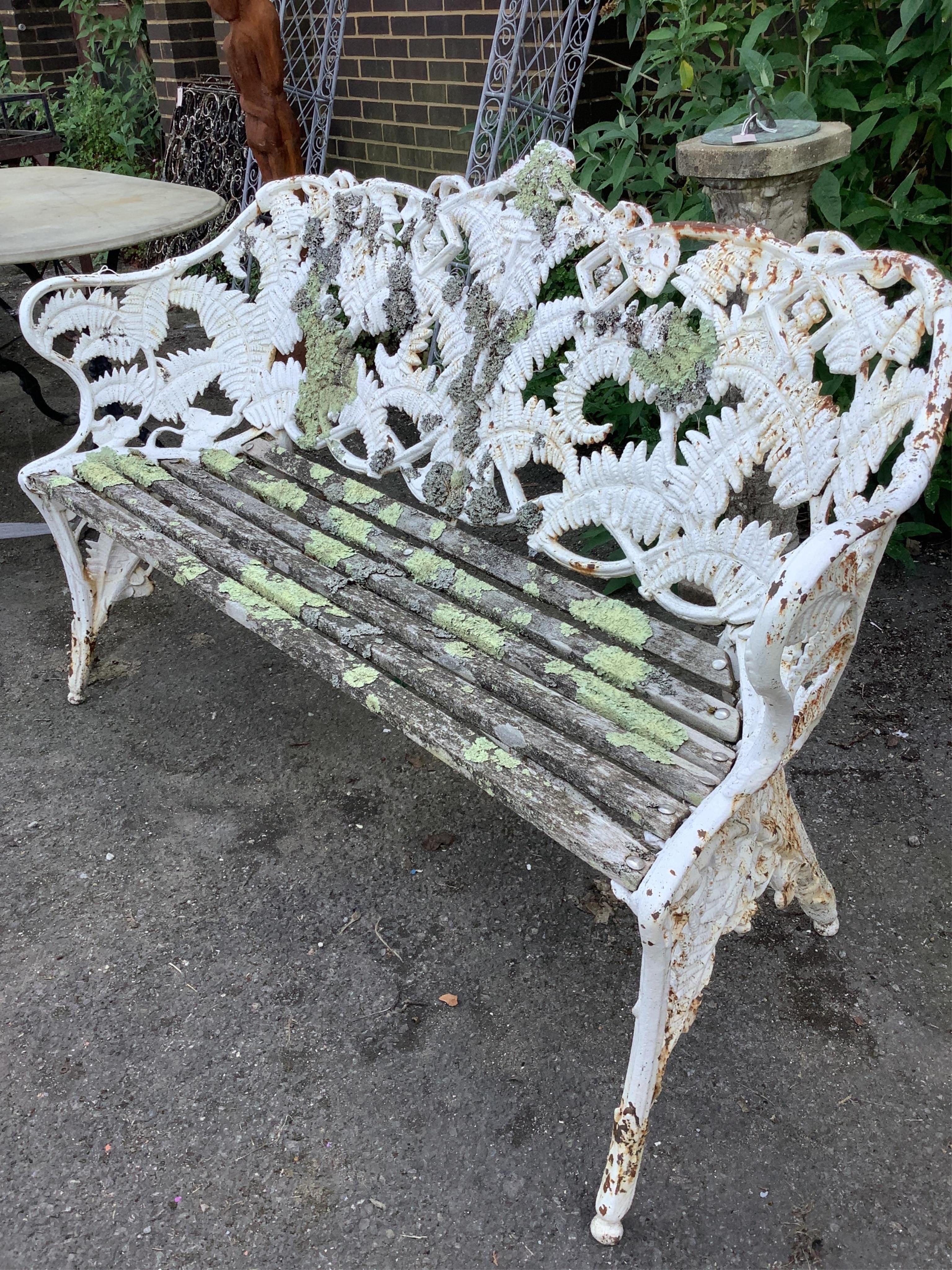 A Victorian Coalbrookdale style fern pattern white painted cast iron garden bench, width 152cm, depth 56cm, height 91cm